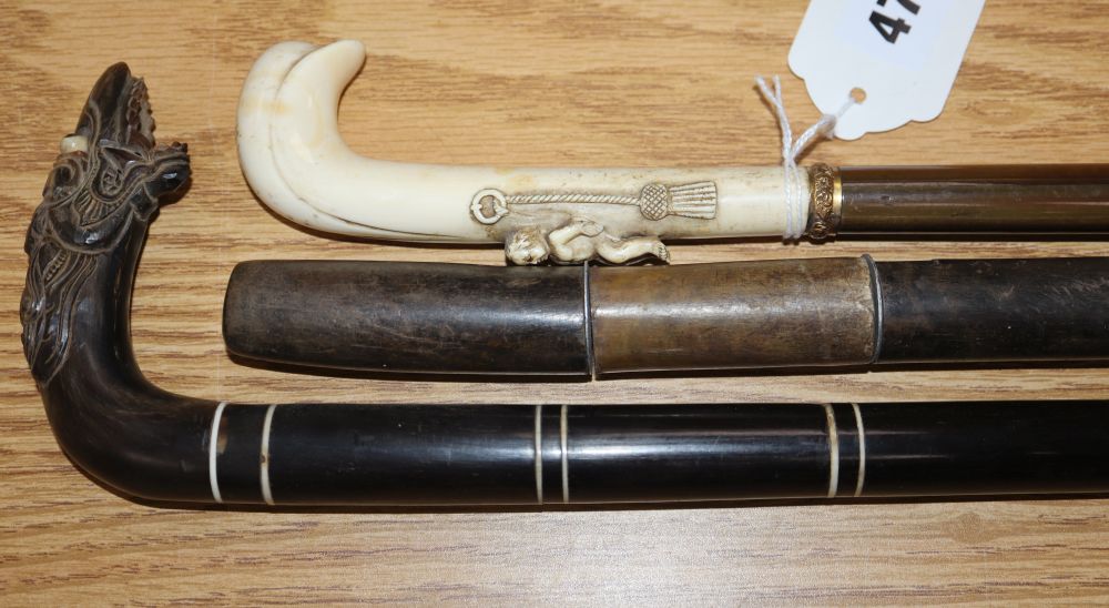 A 19th century ivory handled horn walking stick and two banded horn walking sticks 66.5 - 84cm (3)